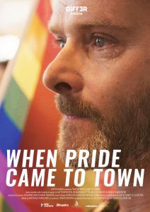 When pride came to town - Man crying by the LGBTQ flag